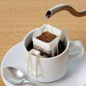Burundi Turihamwe Farms coffee single serve pour over packets with elegant packaging showcasing fresh African beans