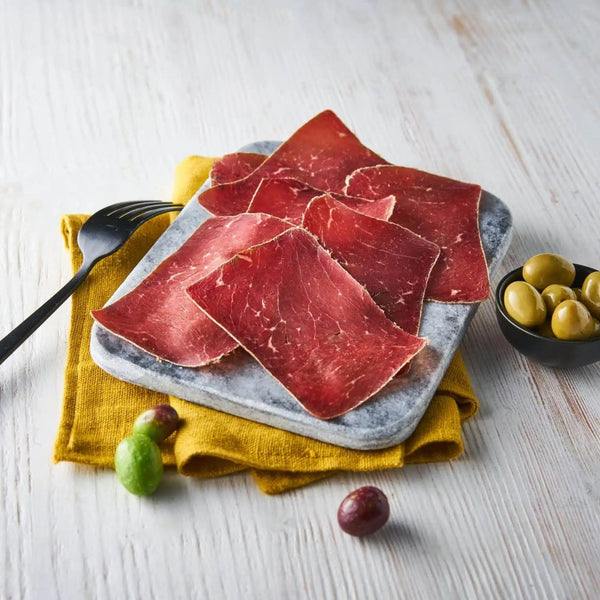 Delicious premium quality Grison air-dried beef slices in vacuum packaging, perfect for charcuterie and gourmet snacking