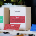 Indian Mooleh Manay single serve pour over coffee sachets in packaging with coffee beans background