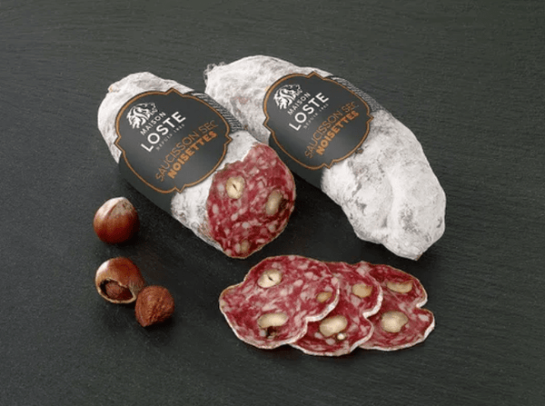 Hazelnut dry cured sausage 250g sliced on wooden board with whole nuts, perfect charcuterie for non-muslim appetizers