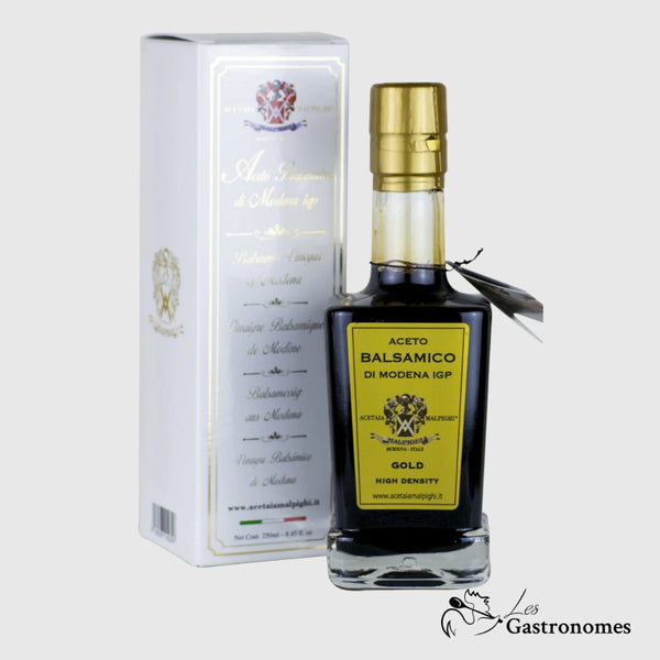 Bottle of premium Acetaia Malpighi gold balsamic vinegar of Modena IGP with elegant packaging and rich amber liquid