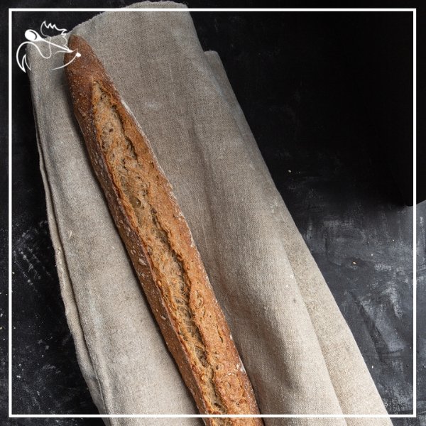 Freshly baked artisan multi-cereal French baguettes with crispy crust and soft interior, perfect for breakfast or dinner