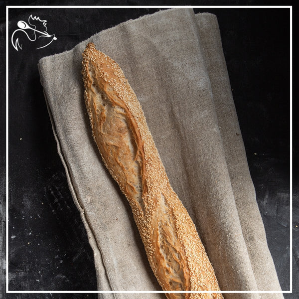 Artisan French baguettes with sesame seeds freshly baked by hand with crispy golden crust, perfect for sandwiches