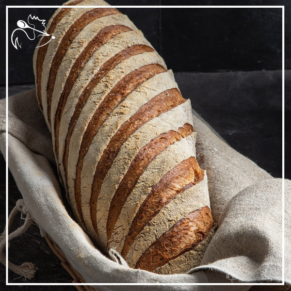 Freshly baked artisan rye bread loaf with crispy crust and soft interior, perfect for sandwiches and breakfast