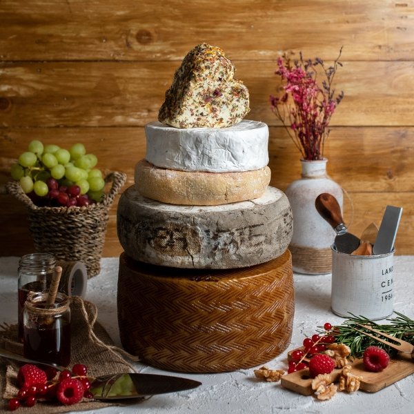 Cheese tower arrangement with a variety of artisanal cheeses stacked elegantly, perfect for special occasions and gatherings