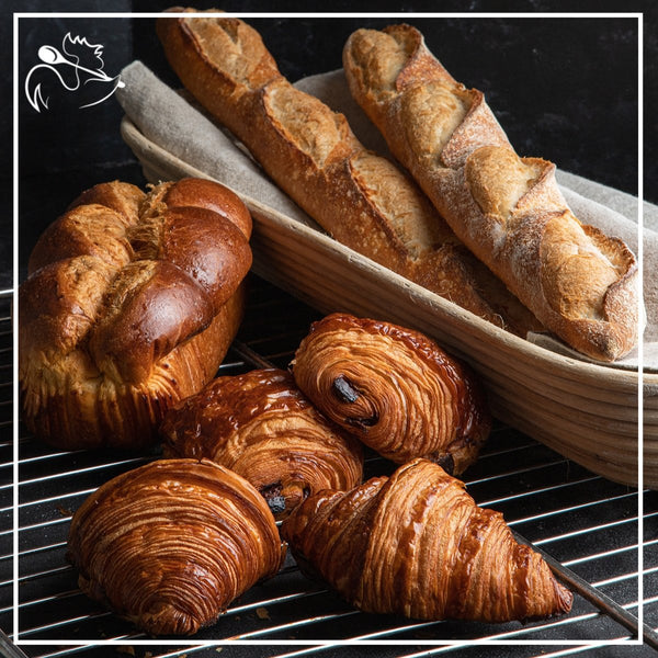 Continental breakfast spread with bread, pastries, jams, and berries for the family to enjoy together