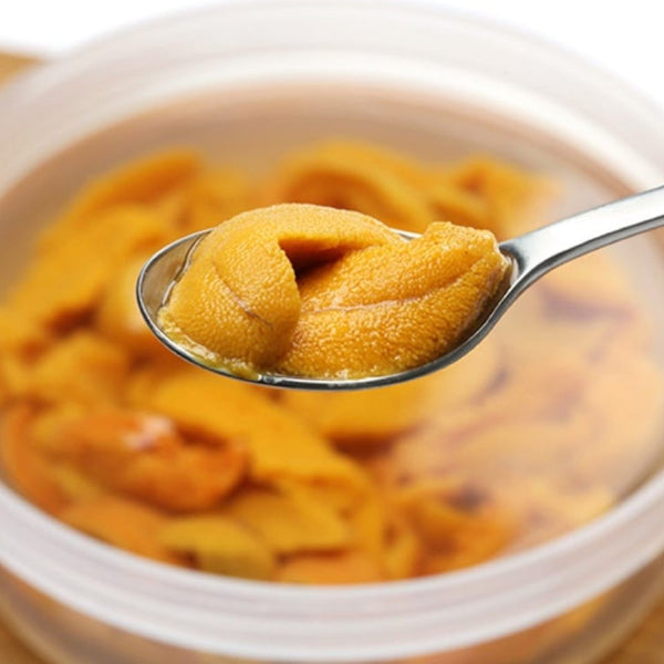 Fresh Japanese uni sea urchin roe preserved in salt water, packaged in a 100g container for pre-order delivery