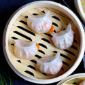 Mixed seafood dumplings pack with 24 pieces, frozen and ready to cook, in a clear packaging showing seafood filling