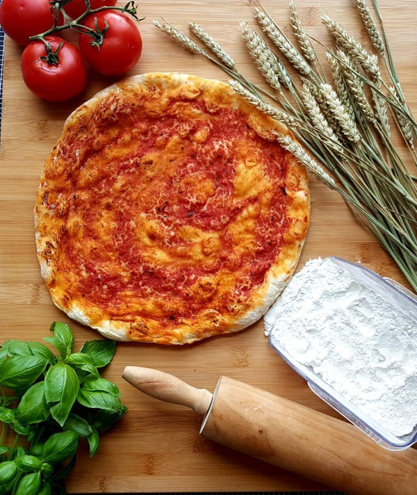 Pre-cooked frozen pizza base with rich tomato sauce ready for toppings, perfect for homemade pizza nights