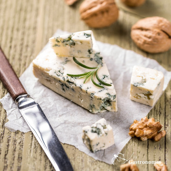 Roquefort AOP blue cheese, a bold and creamy French specialty with distinctive blue veins on a rustic serving board
