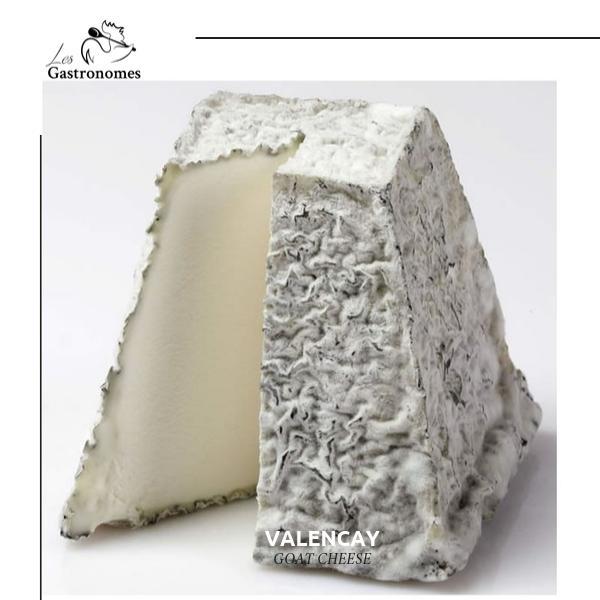 Valencay AOP cheese pyramid with blue-gray mold exterior, creamy interior on rustic wooden board, traditional French artisanal cheese