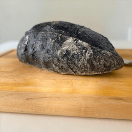 Artisan bread with activated charcoal offering health benefits and unique black color for gourmet food enthusiasts