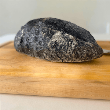 Artisan bread with activated charcoal offering health benefits and unique black color for gourmet food enthusiasts