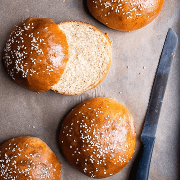Freshly baked artisan brioche burger buns in a pack of 4, golden-brown with soft texture, ideal for gourmet burgers