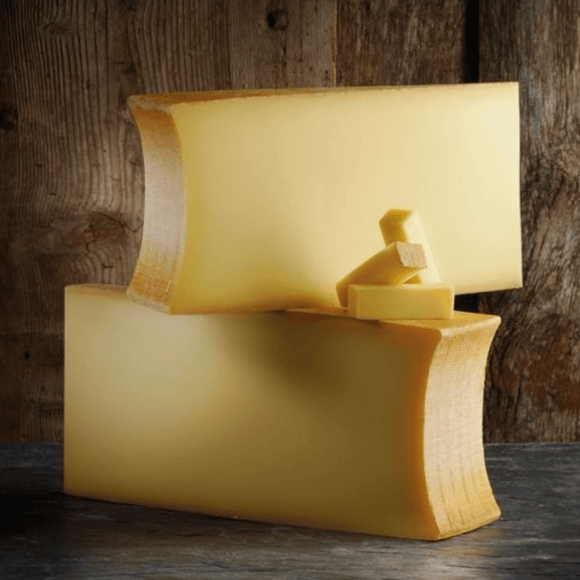 Beaufort tradition AOP cheese wheel from French Alps, aged with raw milk, showing pale yellow texture and natural rind