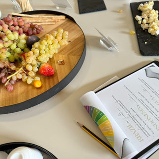 Interactive tasting event showcasing colorful bottles, ingredients and cocktail preparation on a rustic wooden table