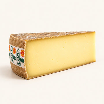 Comté 12 Months 200g wedge, warm ivory studio representation