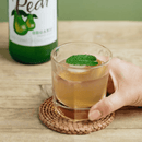 Organic pear juice in a clear glass bottle of 250ml, showing natural fruit drink on white background