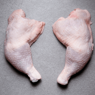 Premium chicken leg from free-range halal-certified poultry with fresh raw meat in retail packaging