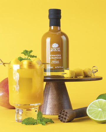Organic vinegar infused with mango in an elegant glass bottle, a gourmet condiment for salads and marinades
