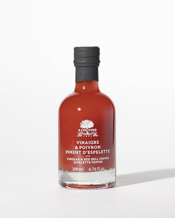 Vinegar infused with red bell pepper and espelette pepper in elegant glass bottle by A L'Olivier, perfect for salads