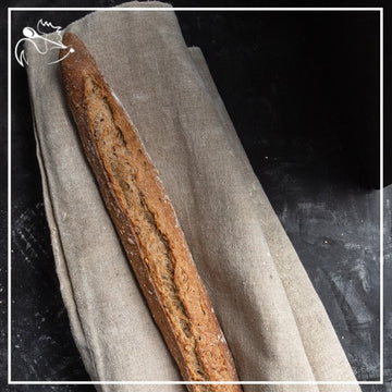 Freshly baked artisan multi-cereal French baguettes with crispy crust and soft interior, perfect for breakfast or dinner