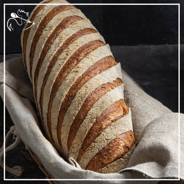 Freshly baked artisan rye bread loaf with crispy crust and soft interior, perfect for sandwiches and breakfast