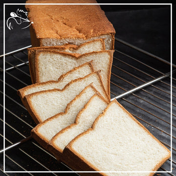 Fresh artisan white toast bread loaf with slices, perfect for breakfast and sandwiches, homemade bakery quality
