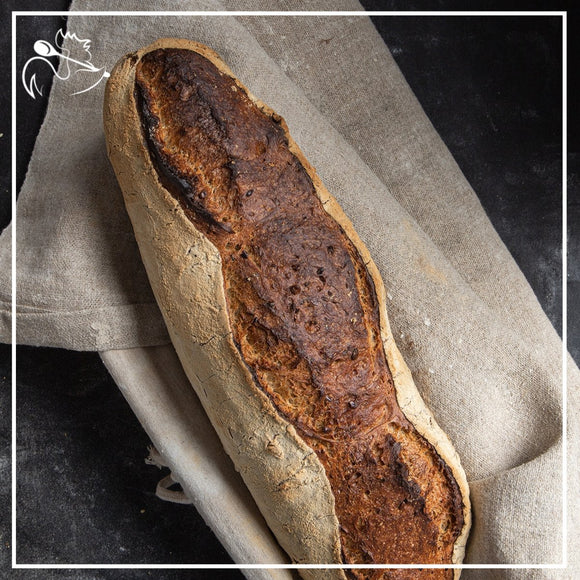 Freshly baked artisan white bread loaf with golden crust and soft interior, perfect for sandwiches and toast