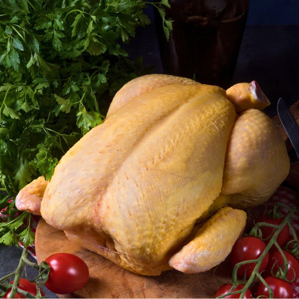 Whole frozen free-range capon from France displayed on white background, perfect for special holiday meals