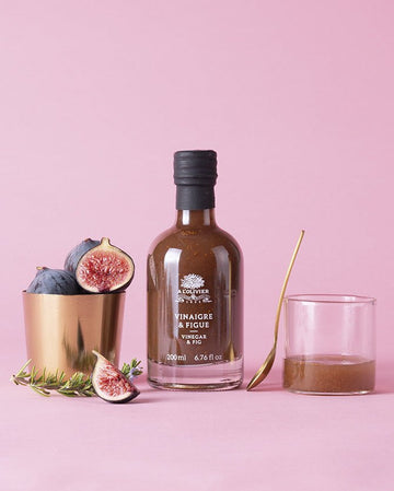 Bottle of L'Olivier Vinegar & Fig infusion, a gourmet balsamic condiment with deep purple color for culinary delights