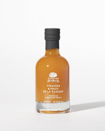 Passion fruit vinegar in a clear glass bottle with a vintage label, perfect for gourmet cooking and salad dressings