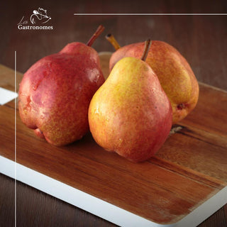 Fresh red William pear with vibrant crimson skin, perfect for snacking or desserts, available individually.