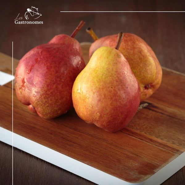 Fresh red William pear with vibrant crimson skin, perfect for snacking or desserts, available individually.