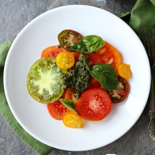 Premium heirloom tomatoes in a rustic wooden crate, approximately 1.5kg of fresh red organic produce