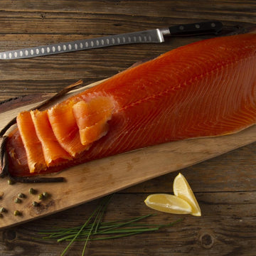 Scottish smoked salmon whole fillet d-cut showing premium quality texture and vibrant color on wooden board
