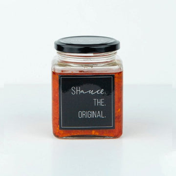 The original SHauce hot sauce 200g bottle with orange cap and spicy chili pepper flavored condiment for meals